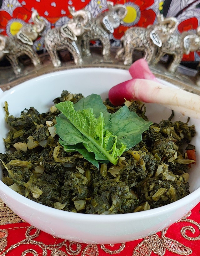 Aromatic mouthwatering homemade mooli ka saag in a white bowl. 