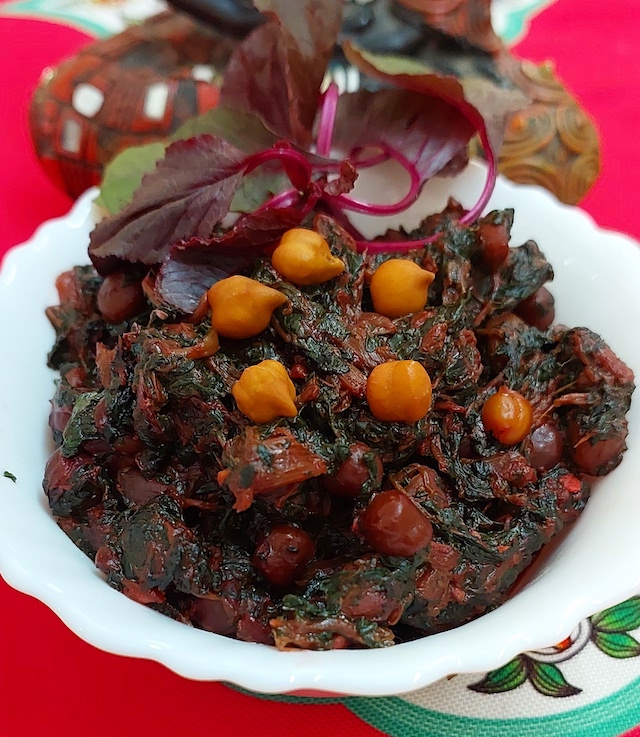 Lal Saag/Cholye/Red Spinach/Amarnath with bengal grams, symbolising the dish's rich flavors and nutritional value.