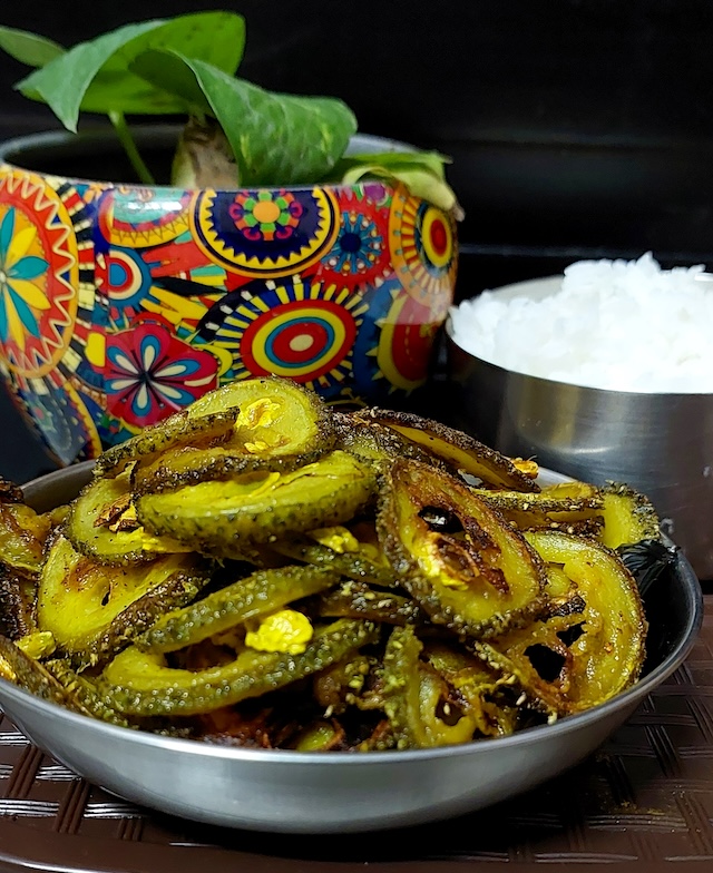 A plate of golden-brown Kakrol ki Recipe - Spiny Gourd Fry, Crispy Delight, showcasing the crispy texture.