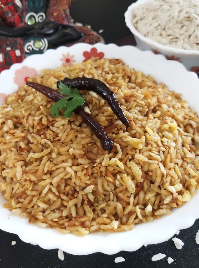 poha chivda recipe(Bhuna Chivda) served in white bowl with dry red chili.