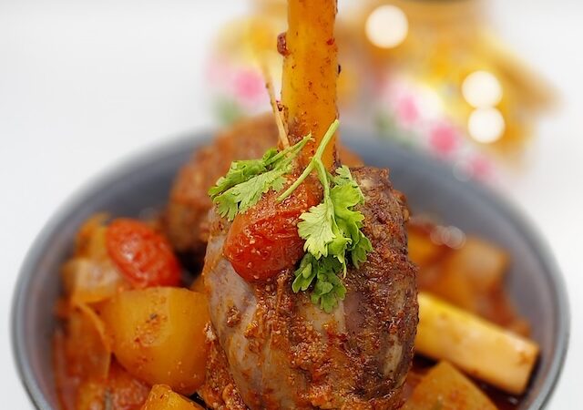 Slow-Cooked Lamb Shank with Vegetables: "Tender slow-cooked lamb shank served with potatoes, carrots and onions.