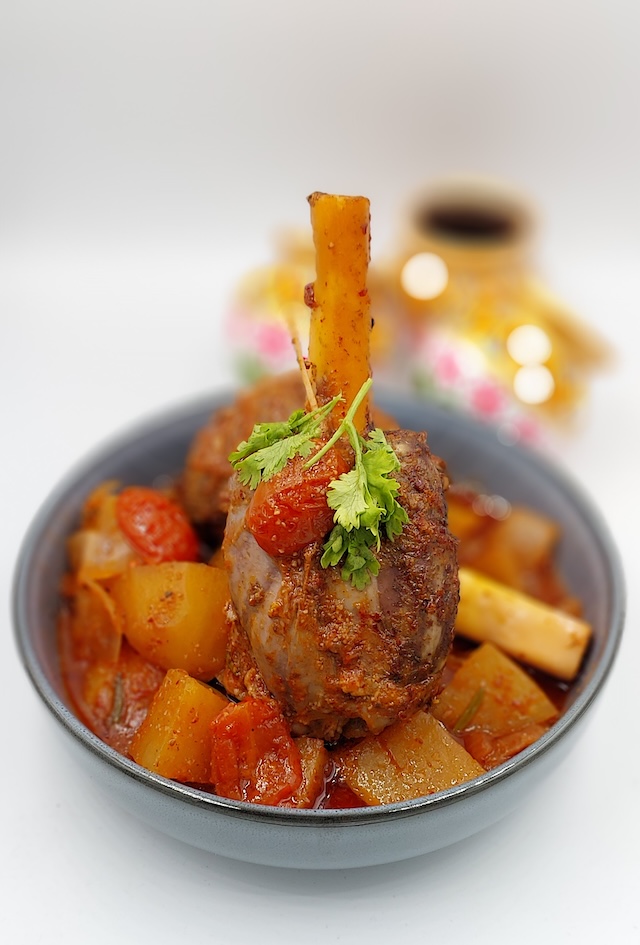 Slow-Cooked Lamb Shank with Vegetables: "Tender slow-cooked lamb shank served with potatoes, carrots and onions.