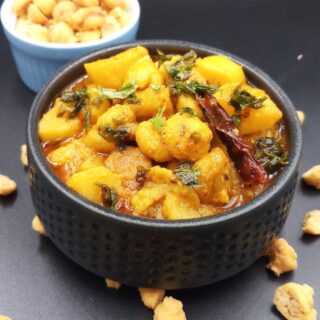 A bowl of Aloo Badi Ki Sabji garnished with fresh coriander leaves.