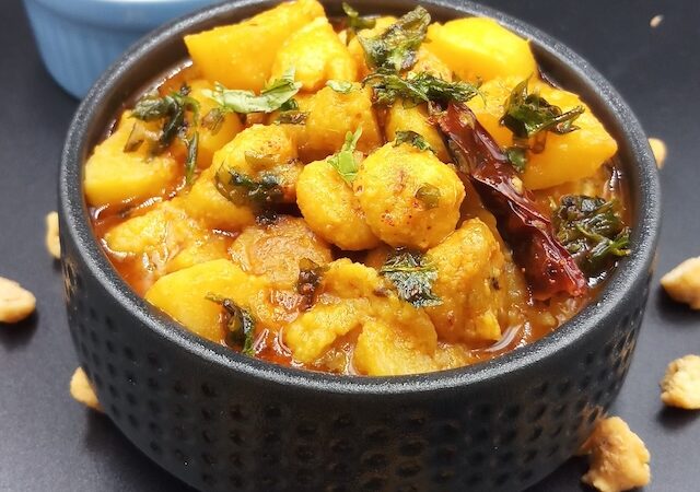 A bowl of Aloo Badi Ki Sabji garnished with fresh coriander leaves.